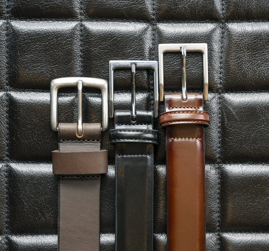 Florsheim accessories featuring a variety of Florsheim leather belts on a black background.