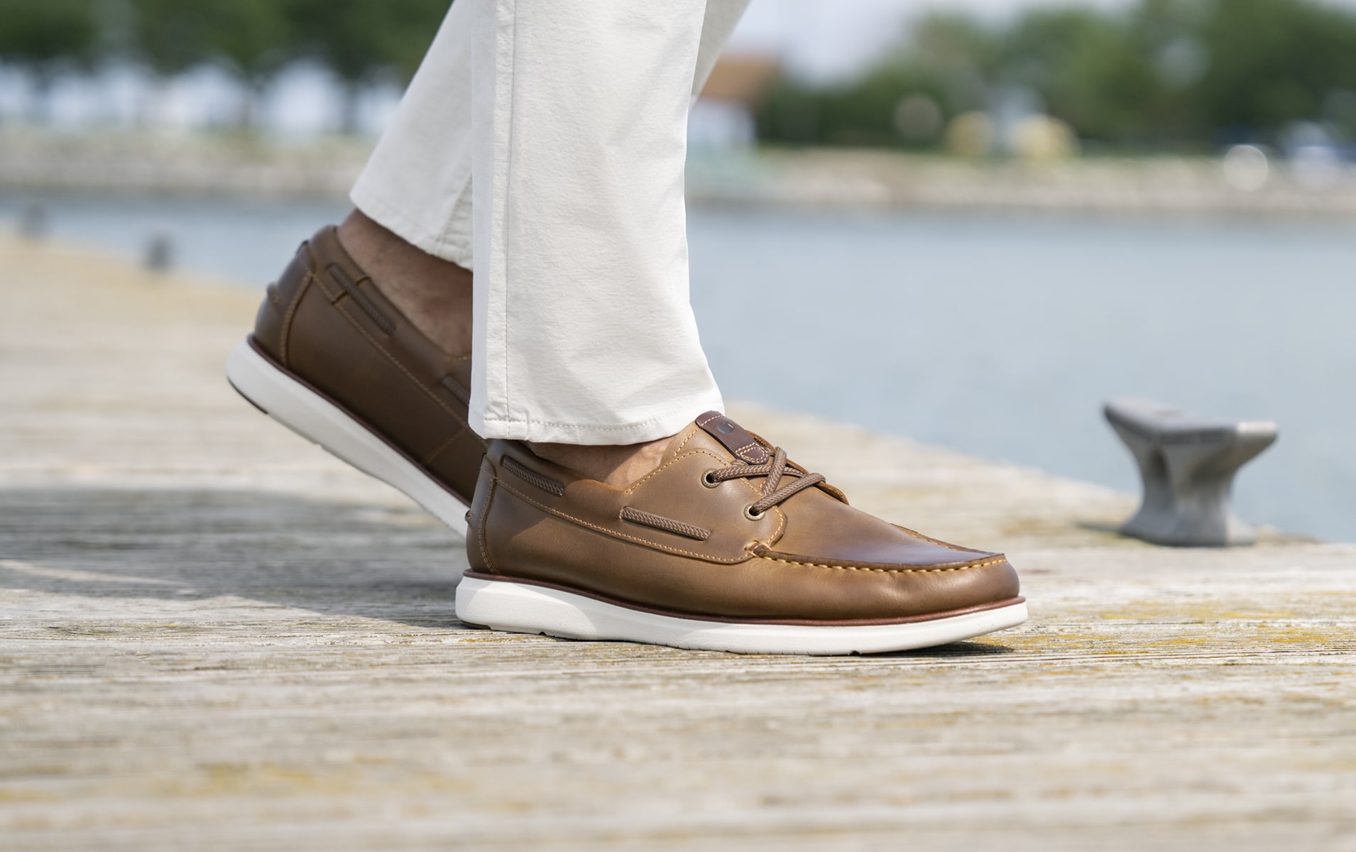 Image features the Tropics boat shoe in brown on a dock.