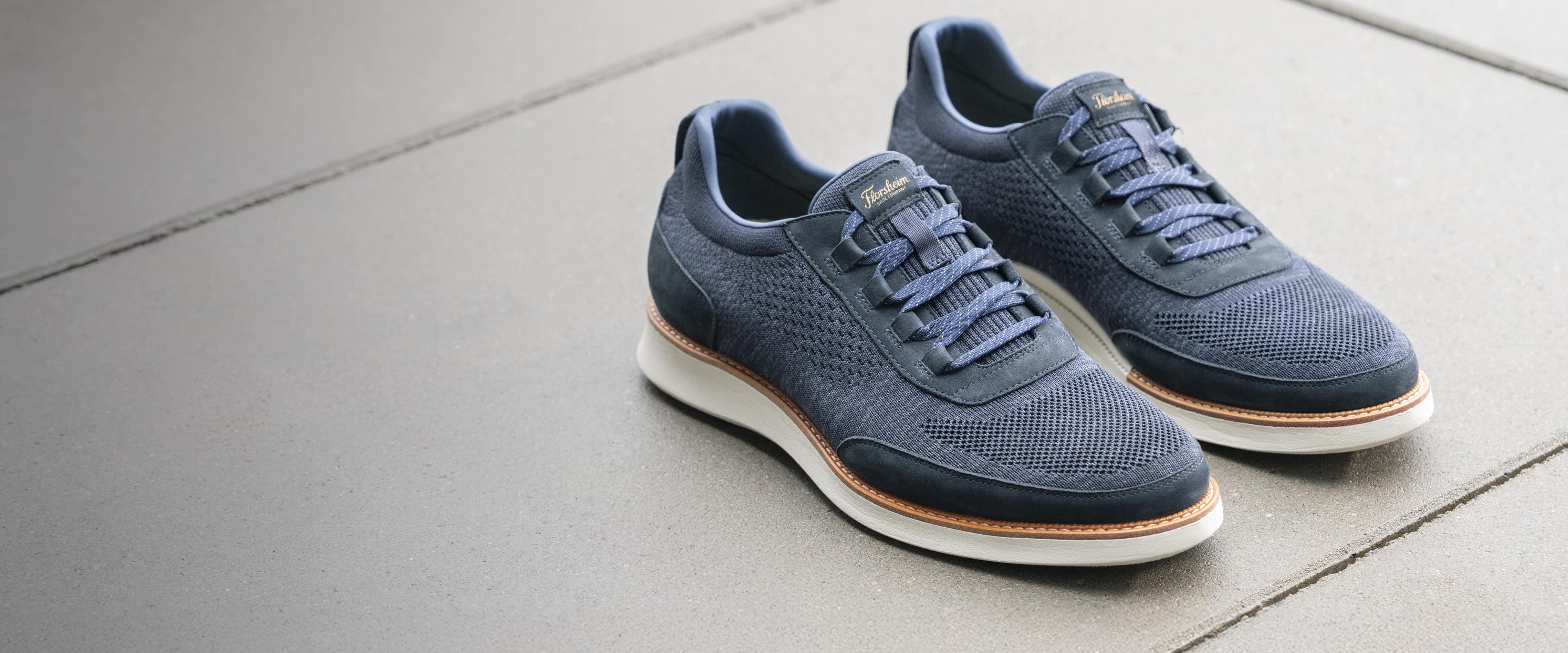 Image features the Launch Knit elastic lace slip on in navy.