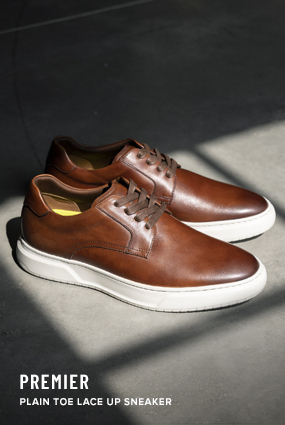  The image features the Premier Plain Toe Lace Up Sneaker in Cognac.