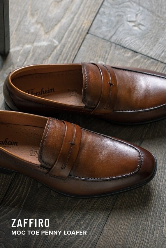 Men's Loafers & Slip Ons category. Image features the Zaffiro penny loafer in cognac. 