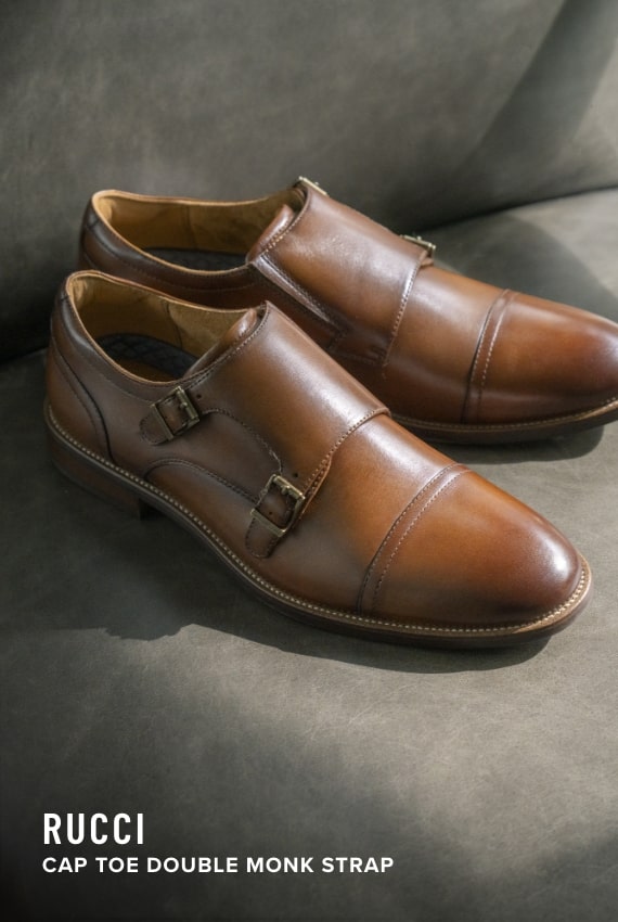 Men's Dress Shoes category. Image features the Rucci Cap Toe Double Monk Strap in cognac.